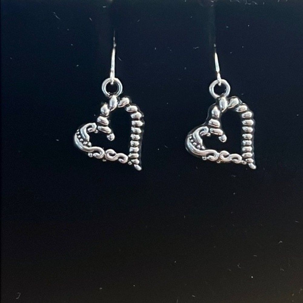 Handcrafted silver tone heart earrings.